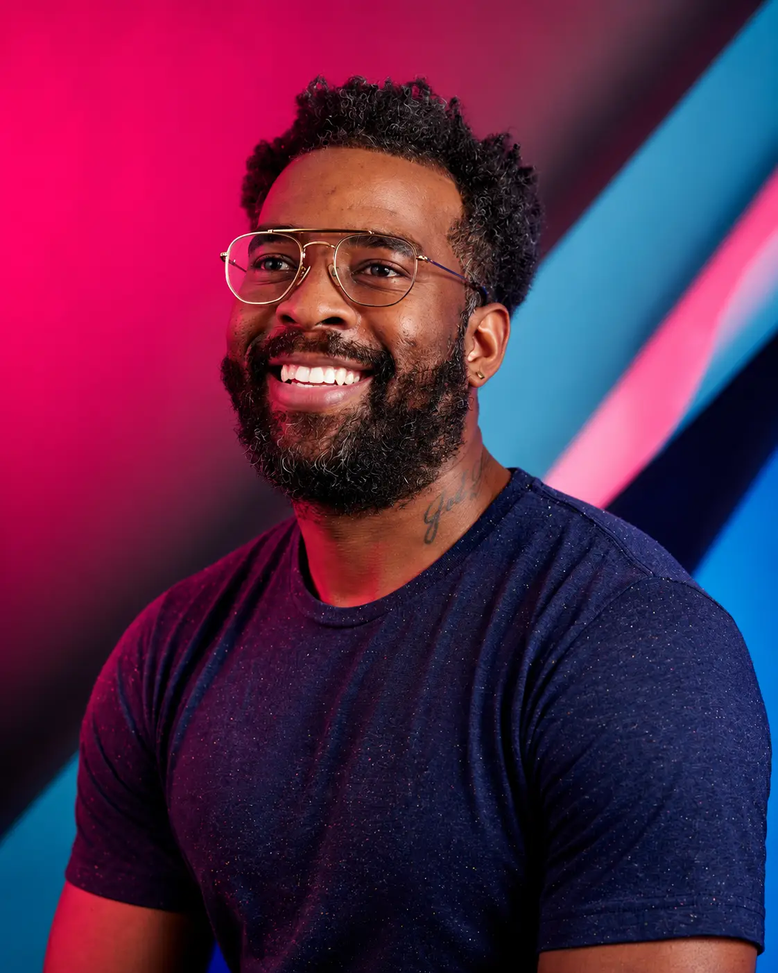Lamar Gibbs smiling in a navy T-shirt